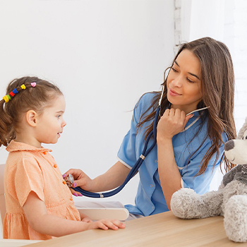 Image of a doctor listening to a girl's heartbeat